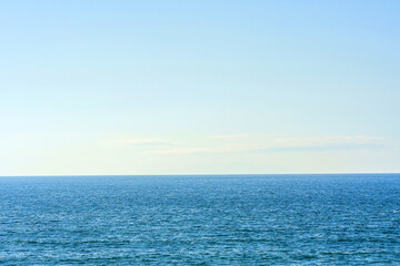 Beautiful summer seascape with clouds and a clear blue sky, background for summer vacation concept.
