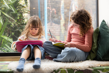 Two girls engaged in creative activities indoors