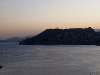 calm evening landscape, serene sunset over quiet bay, peaceful headland scene with pastel sky