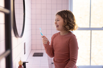 Child Brushing Teeth in Stylish Bathroom Setting