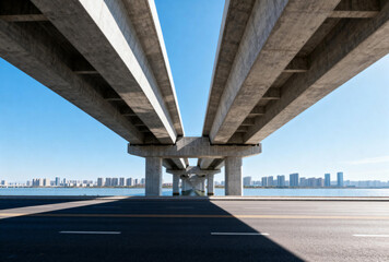 Concrete Viaduct Over Empty Road with City Skyline