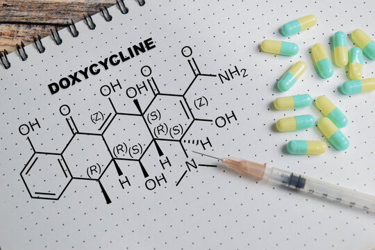 Concept of chemical structure doxycycline write on clipboard isolated on Wooden Table.