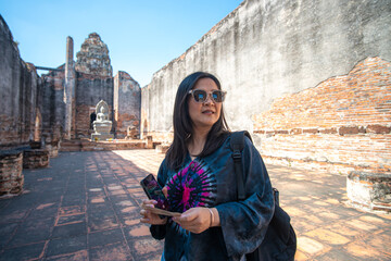 Fototapeta premium Beautiful asian woman backpack travel in ancient buddhist temple