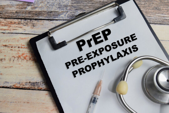 Concept of PrEP - Pre-Exposure Prophylaxis write on clipboard isolated on Wooden Table.