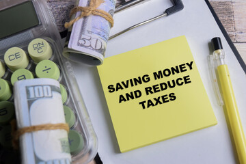 Concept of saving money and reduce taxes write on sticky notes isolated on Wooden Table.