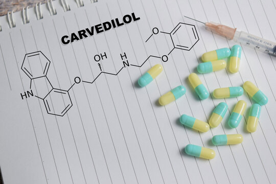 Concept of chemical structure carvedilol write on book isolated on Wooden Table.