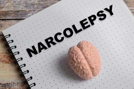 Concept of narcolepsy write on book isolated on Wooden Table.