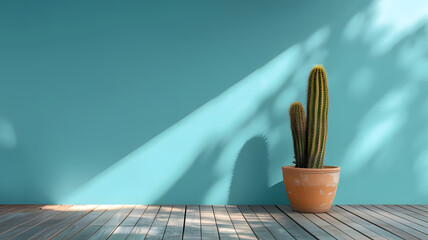 Minimal cactus in terracotta pot on blue wall with copy space