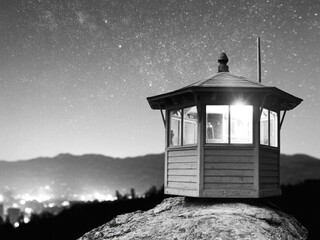 Wooden Fire Lookout Tower Under a Starry Night Sky in Monochrome