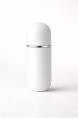 High-end capsule-shaped cosmetic container, minimalist aesthetic, premium beauty packaging photography