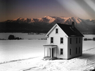 Isolated White House in a Snowy Landscape with Mountains