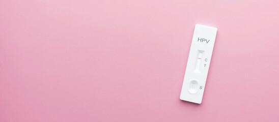 HPV test kit for cervical cancer screening on pink background. Screening tool for at home use, that...