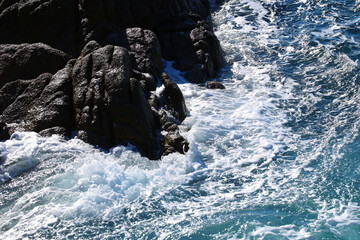 Beach by the sea with foam and spray from the waves