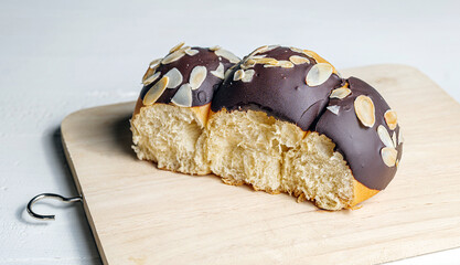 Chocolate covered cream puffs with Almond Slices on wooden Board
