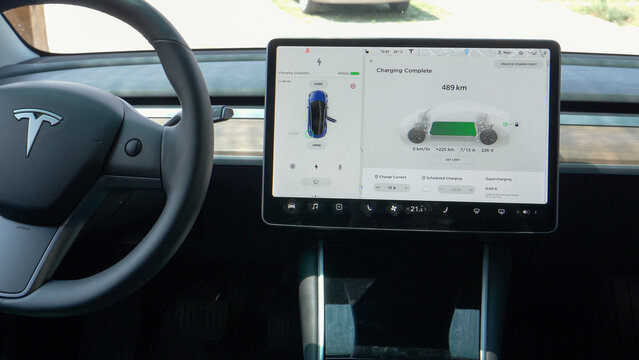 CLOSE UP: Large touchscreen in a new Tesla displays the battery is fully charged