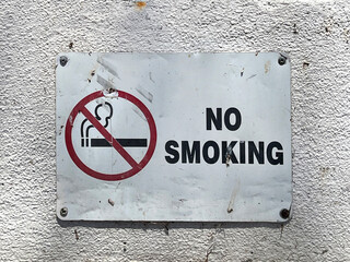NO SMOKING sign on a building wall