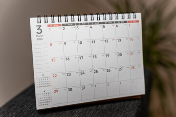 Spiral-bound calendar displaying March 2026 with dates and days of the week visible against a neutral background. Ideal for planning, scheduling, and organizing events.
