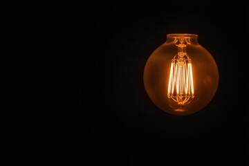 Glowing vintage light bulb on dark background symbol of creativity and idea