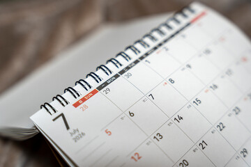 Close-up of a calendar page showing the month of July with dates clearly marked, symbolizing planning and organization for upcoming events and activities.