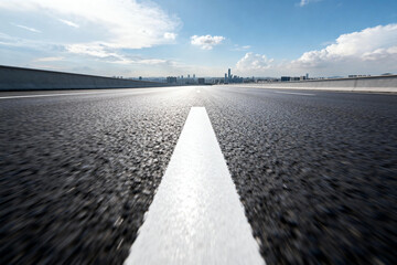 Asphalt Road with White Line Leading to City Skyline