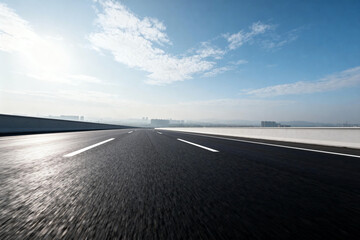 Empty Highway with Clear Blue Sky and Sunlight