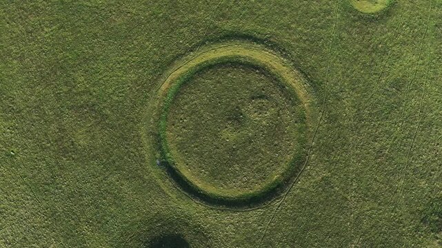Oakley Down Barrow Cemetery, Dorset. Birdseye view of part of main group. Bronze Age mounds and disc barrows. Inhumation and cremation burials. Fly up rotate clockwise