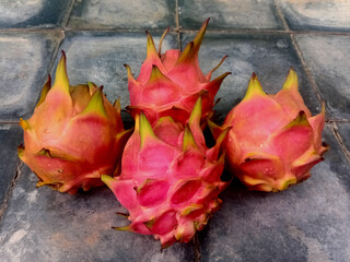 Close up view of fresh dragon fruit isolated on old brick.