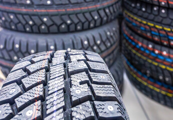 Winter vehicle tires stacked up for sale in the chain hypermarket