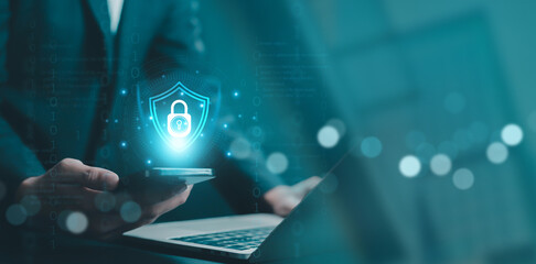 Business professional using laptop with glowing shield and padlock icon representing enterprise cyber security, data protection, secure system access, digital privacy, network safety and information