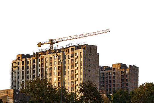 Under construction high multi-storey building with tower type construction crane isolated on transparent, white background. Blank for industry, real estate investment at stage of construction of walls