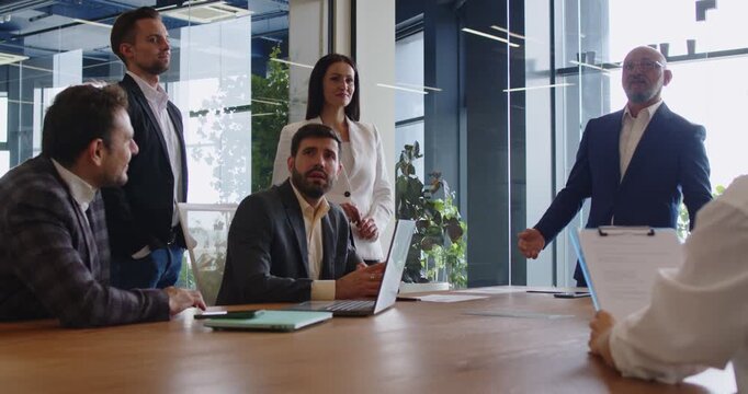 Business meeting with employees and partners team for strategy discussion in office boardroom. Group of people talking and listening presentation of leader, planning company growth and collaboration