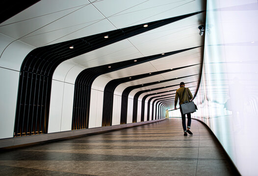 Man walking modern underground tunnel in london