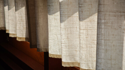 Cream-colored sunshade on the window.