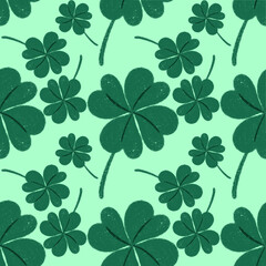 seamless pattern green shamrocks and four-leaf clovers on a light green background.