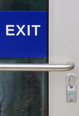EXIT sign on an unlocked building door