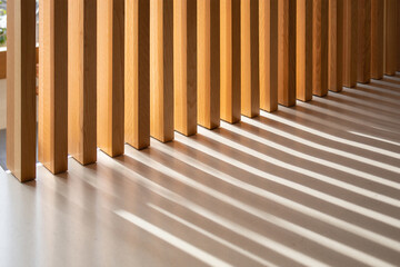 Obraz premium Sunlight casting shadows through vertical wooden slats