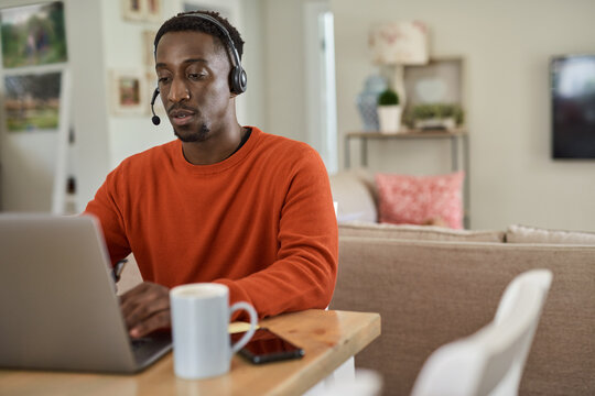 Businessman wearing a headset while working remotely from home
