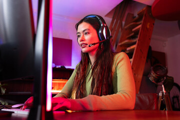 Woman happily streaming a game online at home