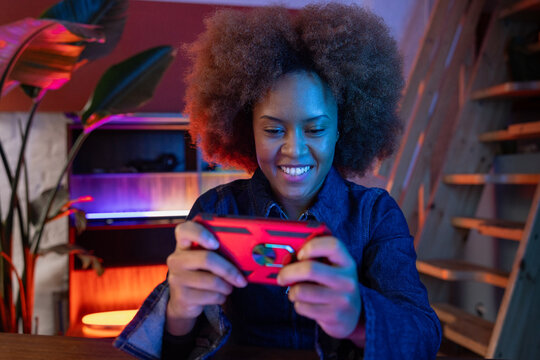 Focused woman playing mobile game with concentration