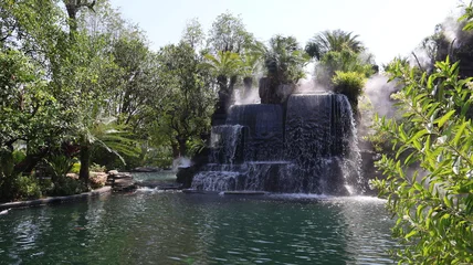 Stickers Ziekenhuis Serene waterfall surrounded by lush greenery, tranquil nature scene ideal for relaxation and meditation, perfect for backdrop.  © MakeitEZ-Img&VID