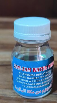 Small bottle of Zamzam water from Mecca with Islamic prayer label, commonly given as an Umrah or Hajj souvenir, symbolizing blessing, faith, and sacred pilgrimage.