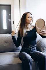 Young woman doing make up and looking into the mirror