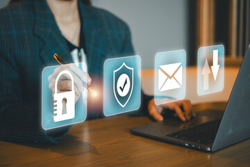 A business professional interacts with digital security icons on a laptop, symbolizing data protection and secure communication.