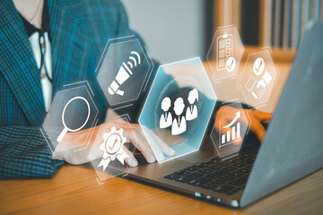 Business professional working on a laptop with digital marketing and data analysis icons overlay, symbolizing modern technology.