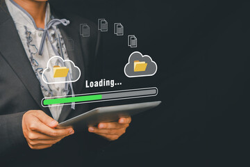 Business professional using a tablet with cloud computing and document transfer icons, symbolizing digital technology and data management.