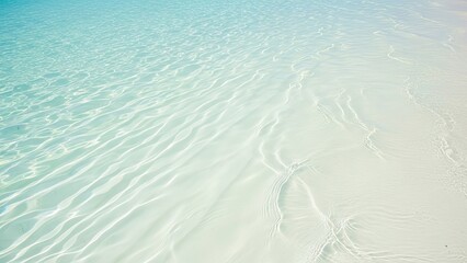 A serene beach scene with clear turquoise water and white sand
