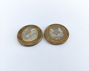 The heads and tails of Singapore 1 Dollar coins, isolated on white background, its detailed and intricate design are ideal for national currency, financial education, numismatics concepts.