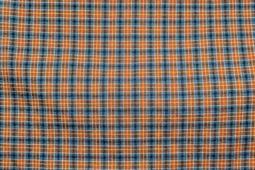 Blue and orange plaid fabric pattern for modern textile design.