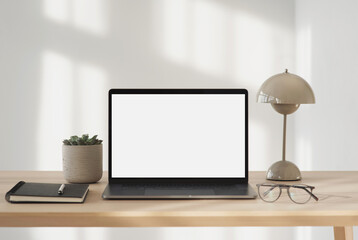 Laptop computer with empty blank mockup screen over white modern living room design. Advertisement, e-learning, shopping online, web site design, technology concept
