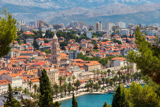 Panoramic view of the historic old town of Split, bustling harbor, and distant mountains from Marjan Hill, Croatia